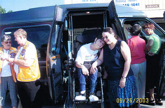 Young Katie Hunn, stricken with Scoliosis, was so surprised when we showed her the van. Here she is with her mother, Janet Gibbons surrounded by some special people.